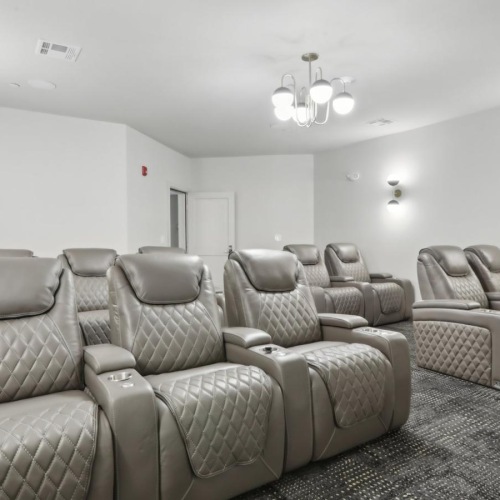 a room with a couch and chairs